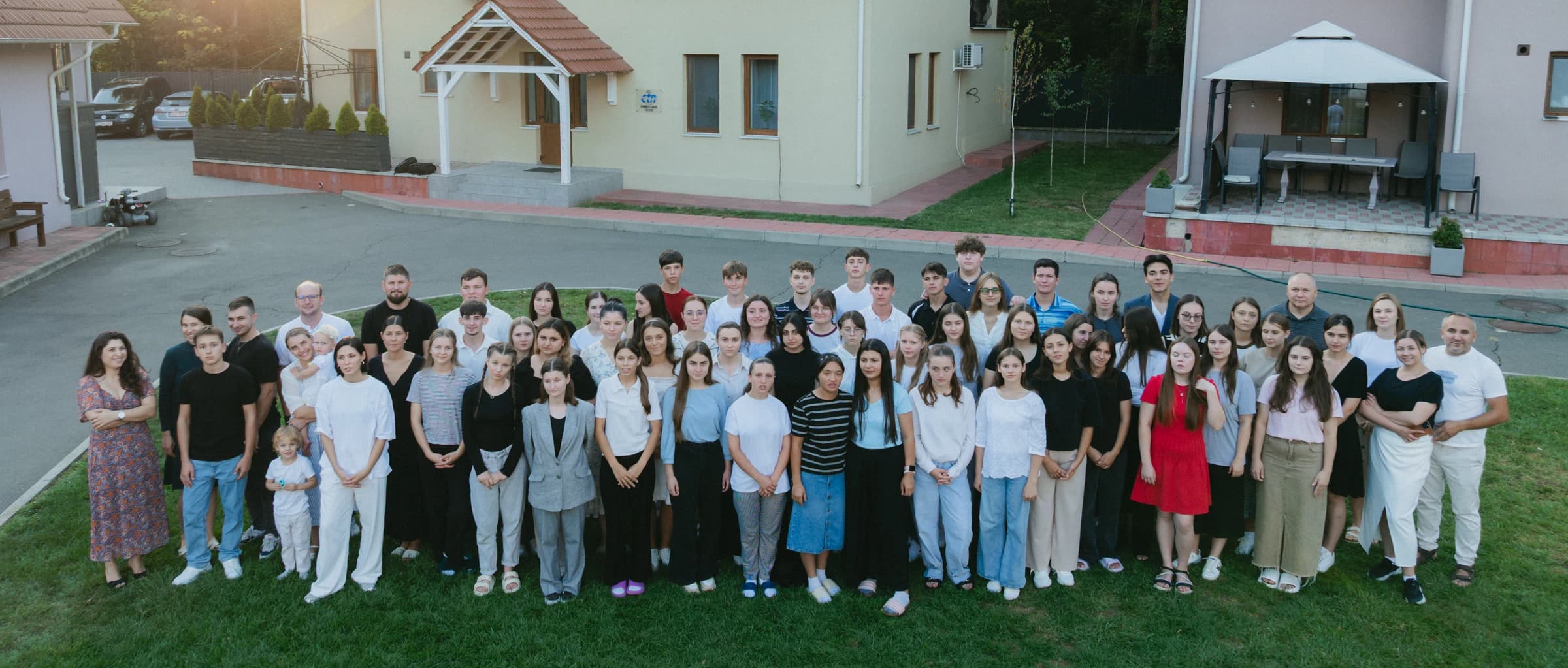 Young people and adults from The Orphan’s Hands gathered together on a lawn